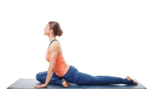 a woman performing Pigeon Pose