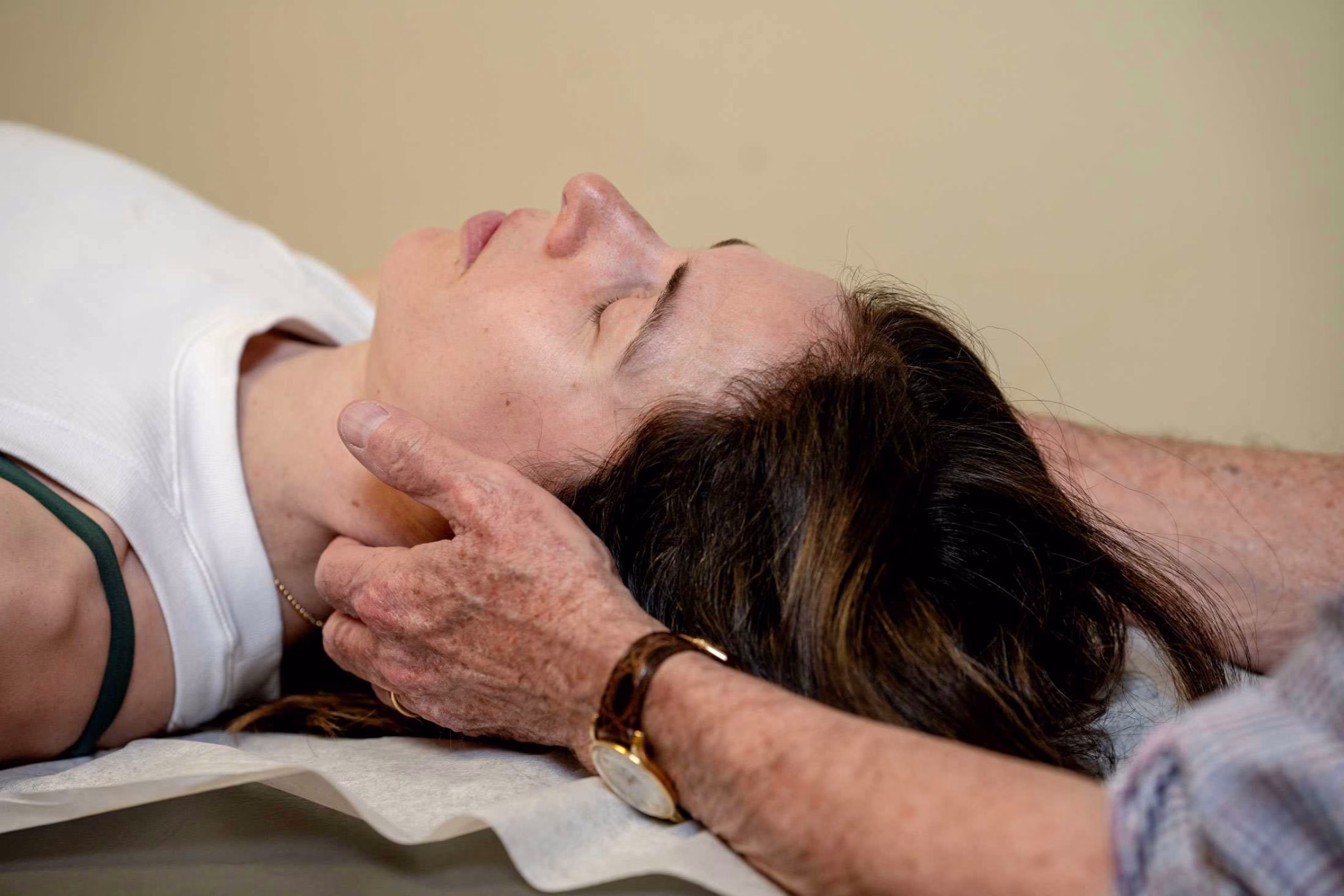 Doctor Robert Minkowsky Assessing the cervical spine of a patient with nerve pain