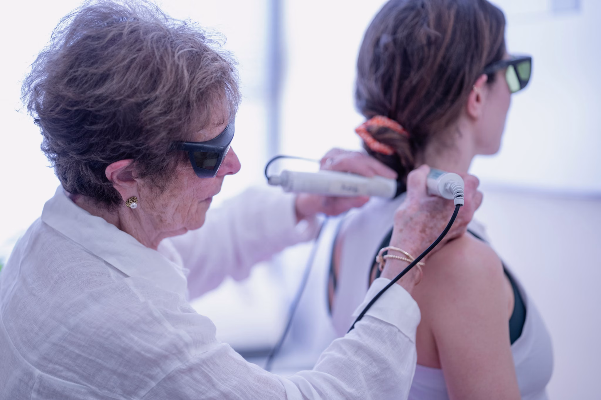 Doctor Irene Minkowsky performs Laser treatment to the cervical spine on a patient with nerve pain