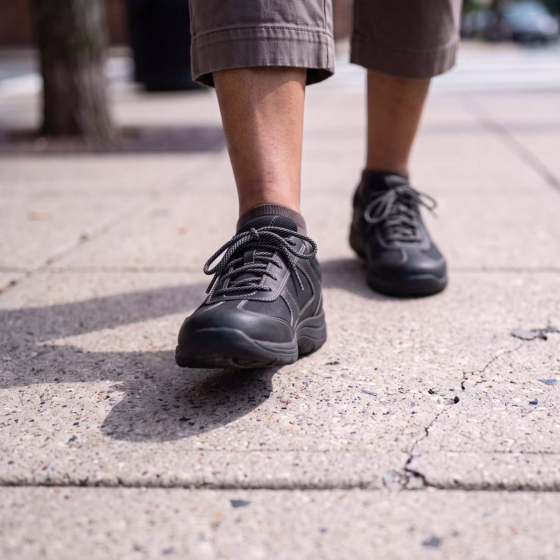 a woman's feet are shown walking down a sidewalk